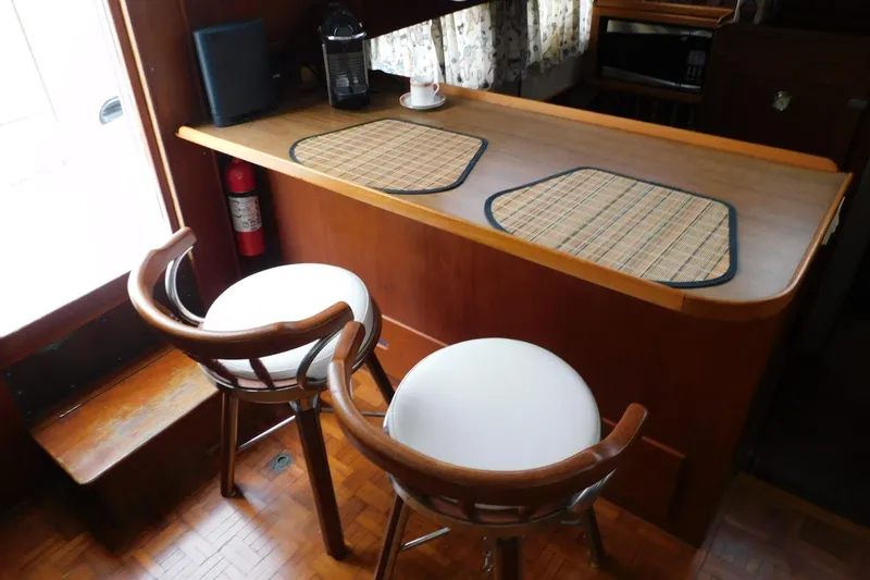 Slide: The Image of Interior of 1986 Grand Banks 46 Classic yacht with bar stools and wooden counter. - 10
