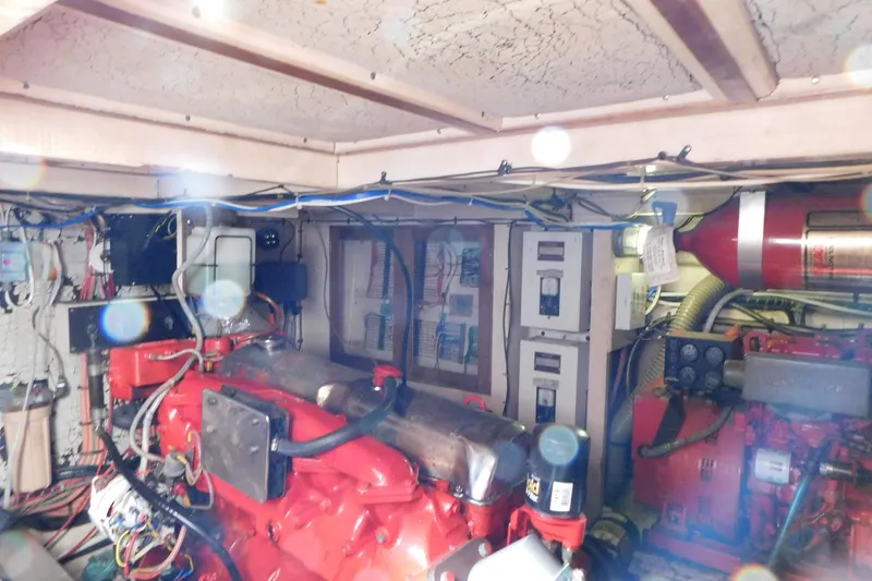 Slide: The Image of Engine room of 1986 Grand Banks 46 Classic yacht with red machinery and wiring. - 24