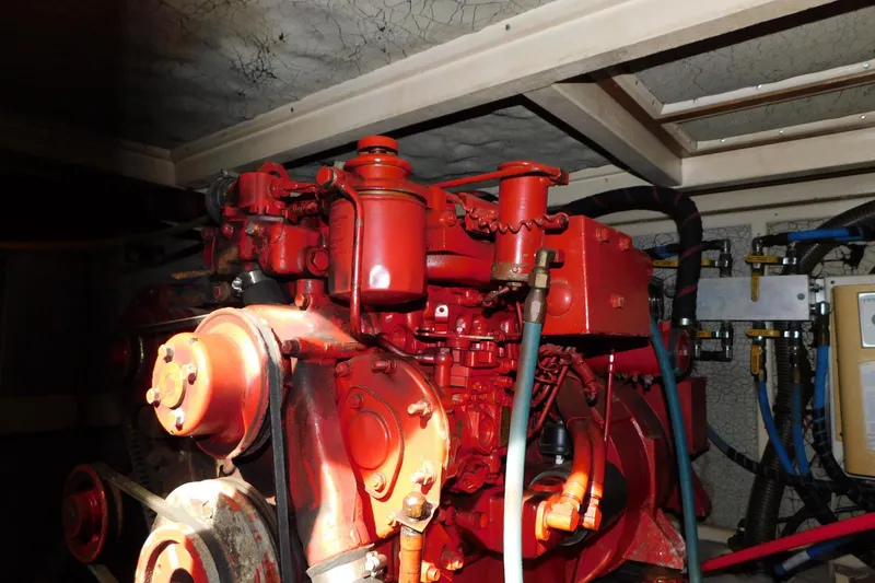 Slide: The Image of Engine room of 1986 Grand Banks 46 Classic yacht with red machinery components. - 25