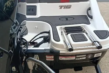 Slide: The Image of 2024 Tahoe T16 boat rear view with swim platform and ladder. - 5