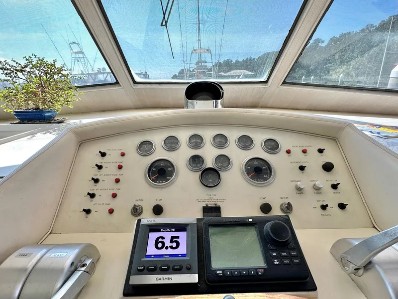 Slide: The Image of 1987 Hatteras 54 Motoryacht helm with gauges, controls, and Garmin display. - 17