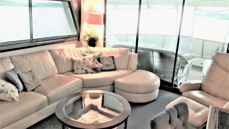 Slide: The Image of Luxurious interior of 1987 Hatteras 54 Motoryacht with plush seating and glass table. - 3