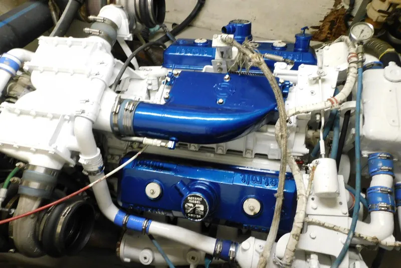 Slide: The Image of Engine of a 1987 Hatteras 54 Motor Yacht, featuring blue and white components. - 43
