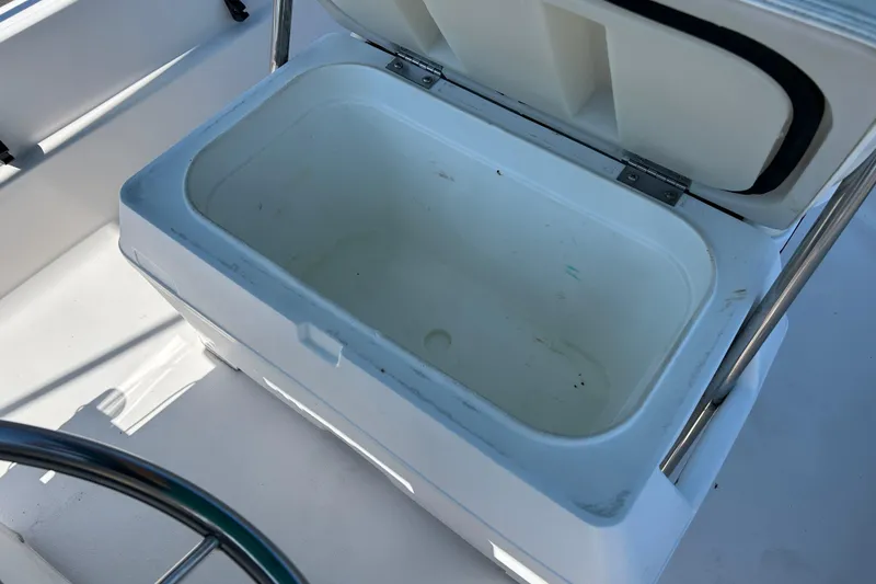Slide: The Image of Open storage compartment on 1996 Wellcraft 160 Fisherman boat, showing interior space. - 14