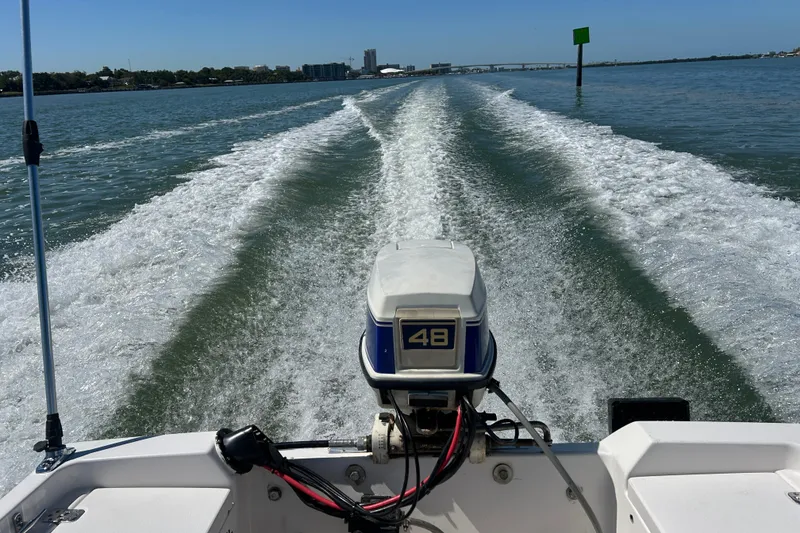 Slide: The Image of 1996 Wellcraft 160 Fisherman boat cruising, leaving a wake on a sunny day. - 18