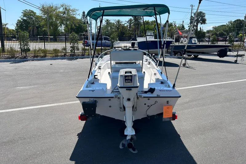 Slide: The Image of 1996 Wellcraft 160 Fisherman boat with outboard motor in a parking lot. - 3