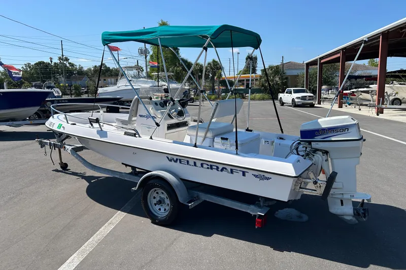 Slide: The Image of 1996 Wellcraft 160 Fisherman boat with Johnson outboard motor on trailer. - 4