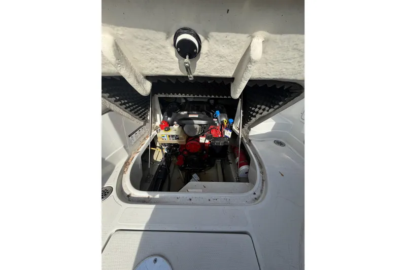 Slide: The Image of Engine compartment of a 2020 Crownline 286 SC boat, showcasing internal components. - 12
