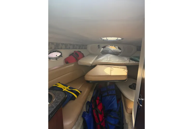 Slide: The Image of Interior of 2020 Crownline 286 SC boat cabin with seating and storage. - 21