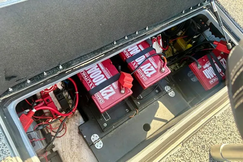 Slide: The Image of Battery compartment of 2022 Nitro Z20 boat with multiple red batteries and wiring. - 10