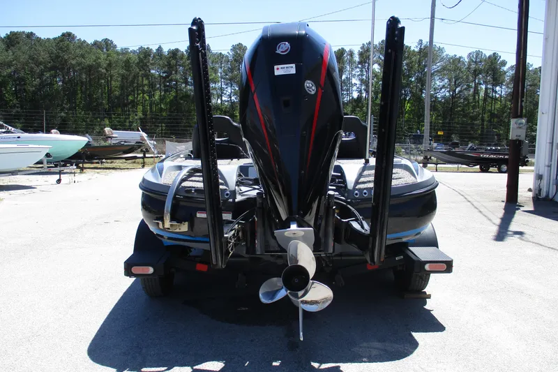 Slide: The Image of 2022 Nitro Z20 boat rear view with powerful outboard motor in a marina setting. - 15