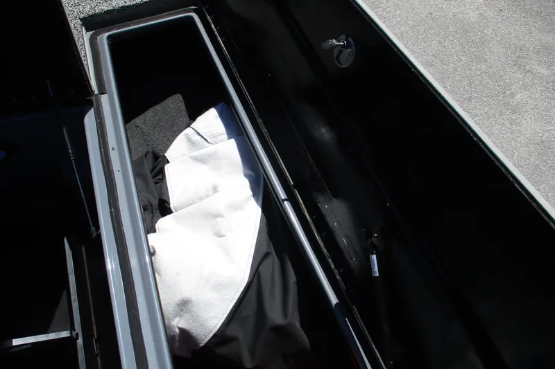 Slide: The Image of Open storage compartment in 2022 Nitro Z20 boat with white and black fabric inside. - 19