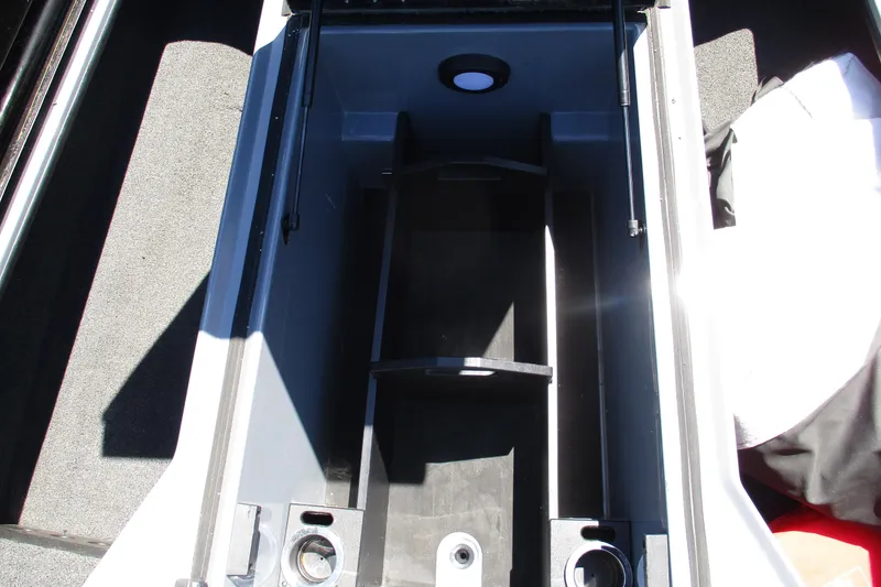 Slide: The Image of 2022 Nitro Z20 boat storage compartment with carpeted interior and organized layout. - 20