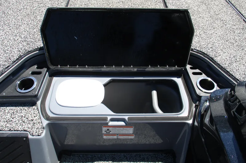 Slide: The Image of 2022 Nitro Z20 boat storage compartment with open lid and cup holders. - 22