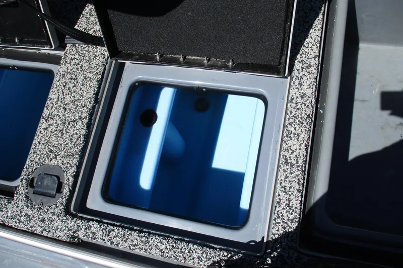 Slide: The Image of Open storage compartment in a 2022 Nitro Z20 boat, featuring a blue interior. - 27