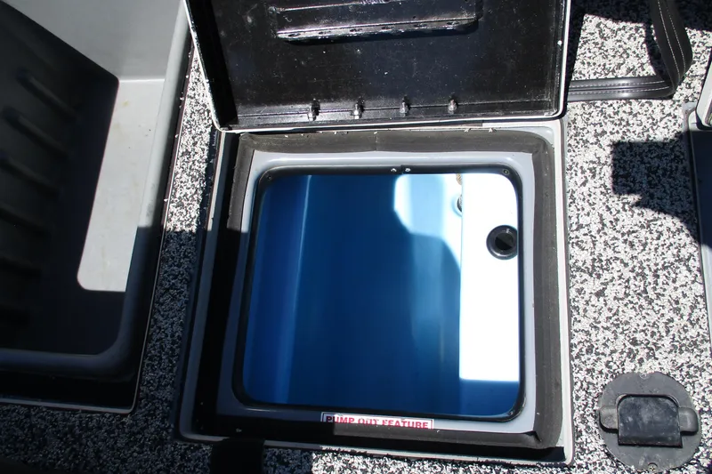 Slide: The Image of Open storage compartment on a 2022 Nitro Z20 boat, featuring a blue interior. - 28