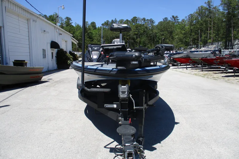 Slide: The Image of 2022 Nitro Z20 boat on trailer, parked outdoors near a building and other boats. - 3