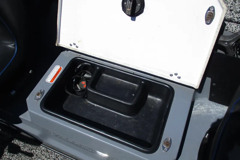 Slide: The Image of Open storage compartment in a 2022 Nitro Z20 boat, featuring a black interior. - 31