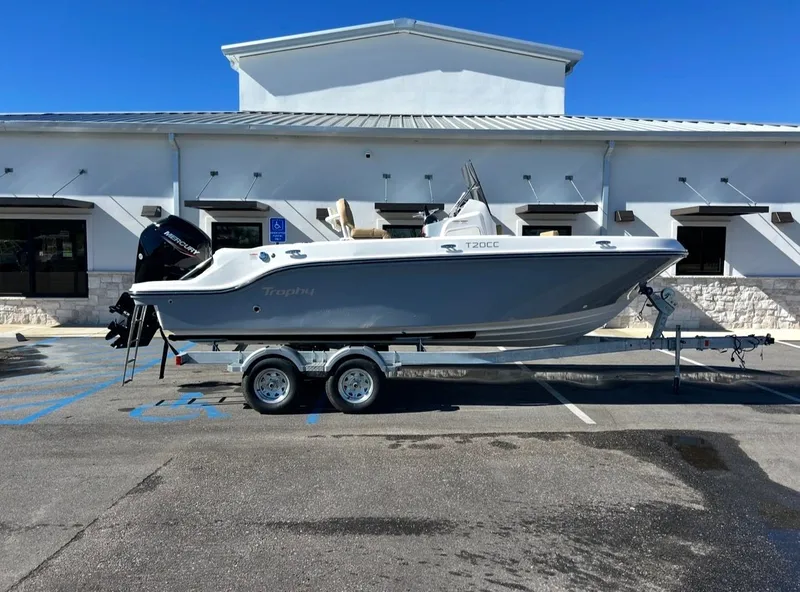 The Image of 2026 Bayliner TROPHY CC20 boat on trailer in front of building. - 1
