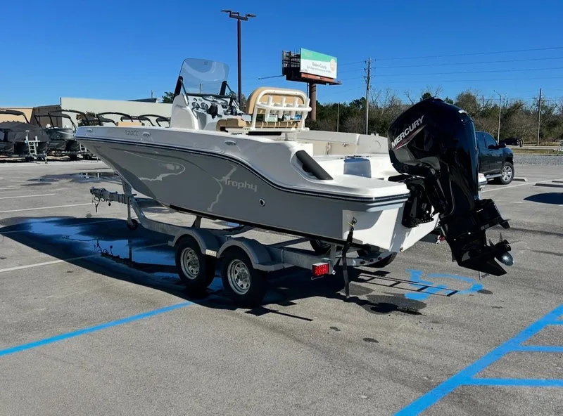Slide: The Image of 2026 Bayliner TROPHY CC20 boat parked on trailer outdoors. - 6