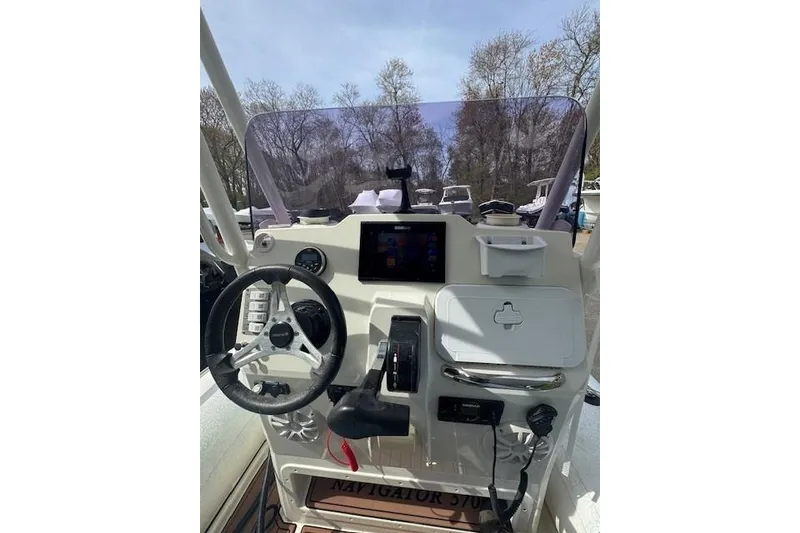 Slide: The Image of 2019 Brig Navigator 570 boat dashboard with steering wheel and control panel. - 4