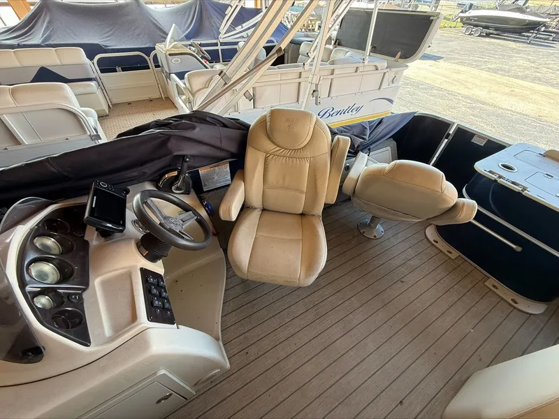 Slide: The Image of Interior of a 2018 Sylvan 8522 pontoon boat with steering wheel and seats. - 7
