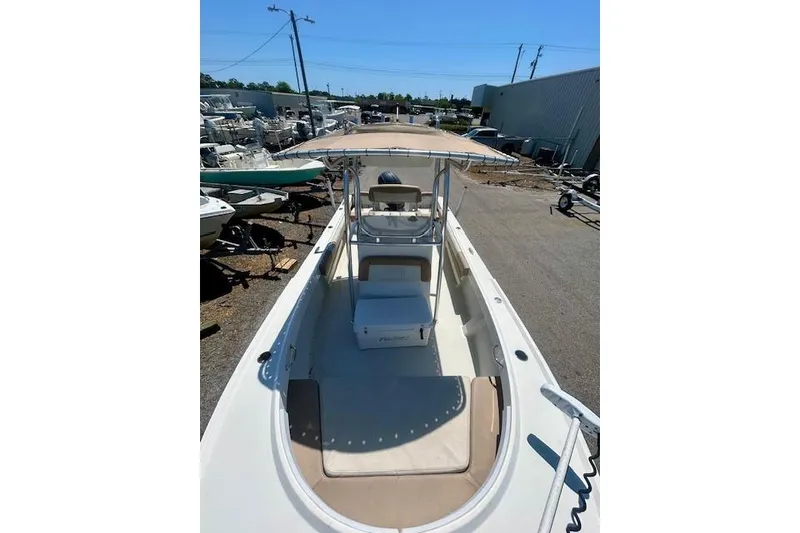 Slide: The Image of 2019 Parker 21 Special Edition boat with canopy, docked outdoors. - 2