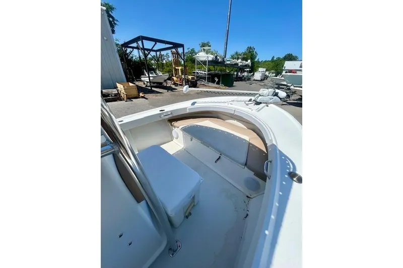 Slide: The Image of 2019 Parker 21 Special Edition boat interior with seating, docked outdoors. - 3