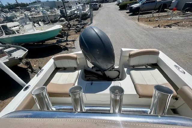 Slide: The Image of 2019 Parker 21 Special Edition boat with seating and rod holders, parked in a marina. - 5