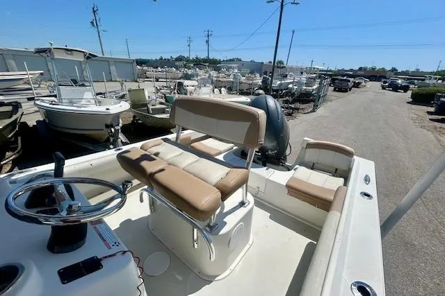 Slide: The Image of 2019 Parker 21 Special Edition boat with tan seating in a marina. - 8