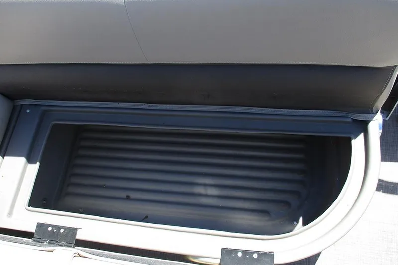 Slide: The Image of 2023 Sun Tracker Bass Buggy 18 DLX storage compartment, open and empty. - 17