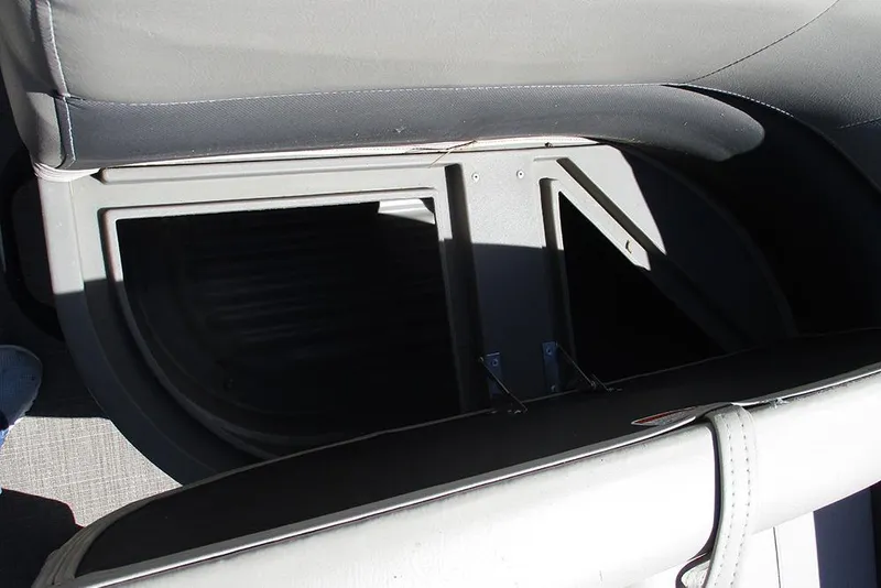 Slide: The Image of 2023 Sun Tracker Bass Buggy 18 DLX storage compartment with open seat view. - 19