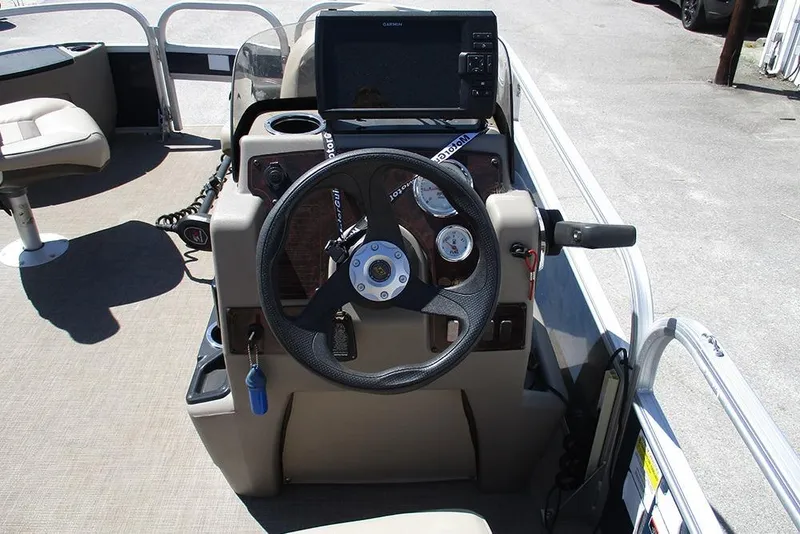 Slide: The Image of 2023 Sun Tracker Bass Buggy 18 DLX steering console with gauges and navigation system. - 23