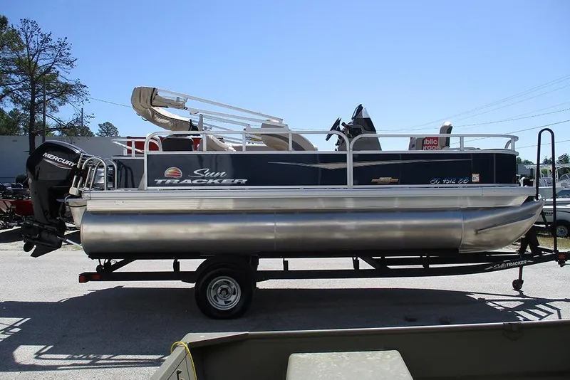 Slide: The Image of 2023 Sun Tracker Bass Buggy 18 DLX pontoon boat on trailer, side view. - 6