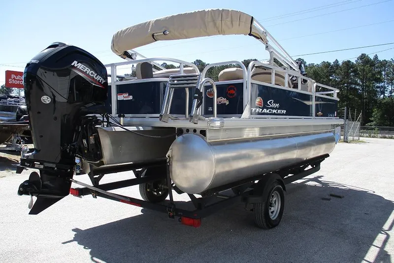 Slide: The Image of 2023 Sun Tracker Bass Buggy 18 DLX pontoon boat with Mercury engine on trailer. - 7