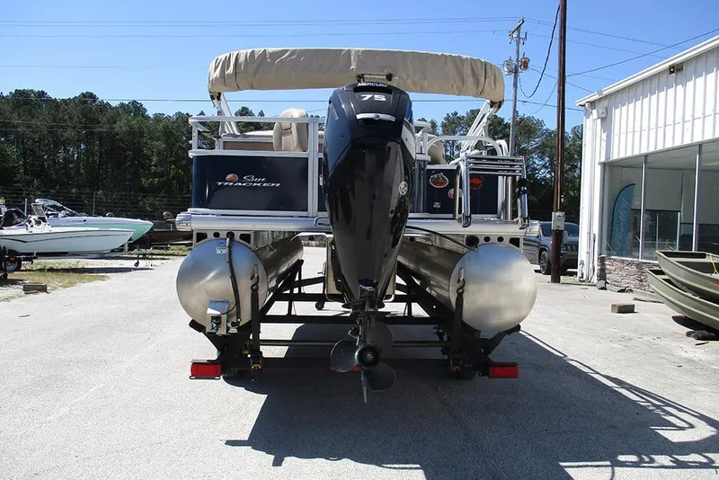 Slide: The Image of 2023 Sun Tracker Bass Buggy 18 DLX pontoon boat with Mercury 75 engine, parked outdoors. - 8