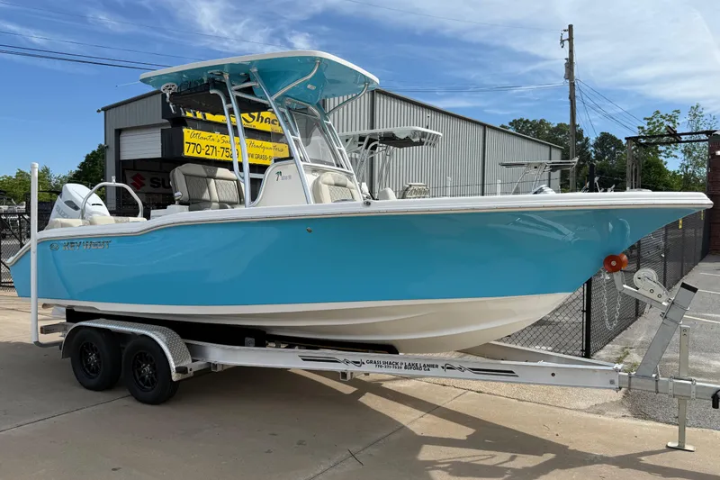 The Image of 2026 Key West 239 FS boat on trailer, blue hull, parked outdoors. - 0