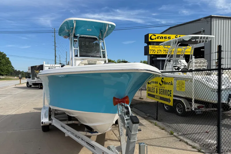 Slide: The Image of 2026 Key West 239 FS boat on trailer at dealership, blue hull, sunny day. - 1