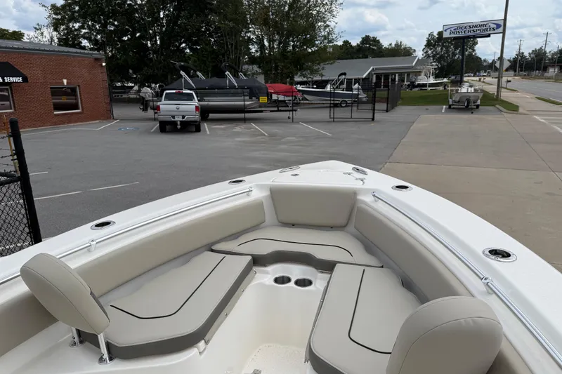 The Image of 2026 Key West 239 FS boat with spacious seating, parked near a dealership. - 10