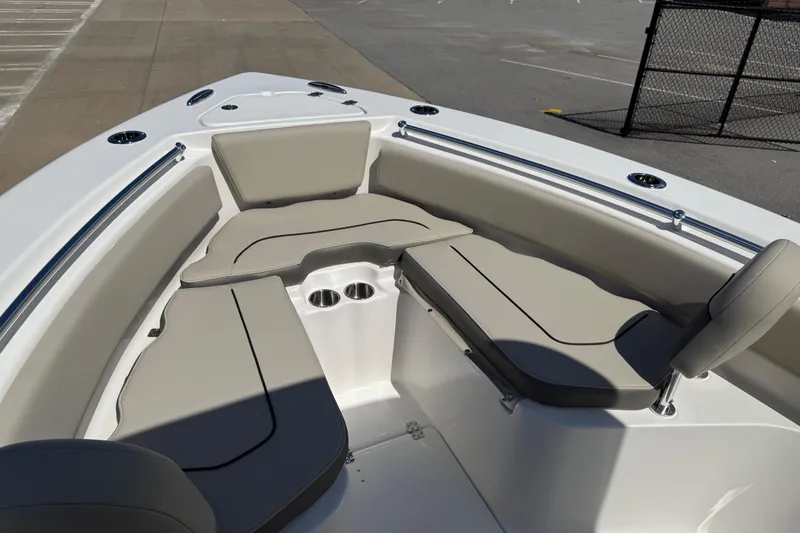 Slide: The Image of 2026 Key West 239 FS boat interior with cushioned seating and cup holders. - 11
