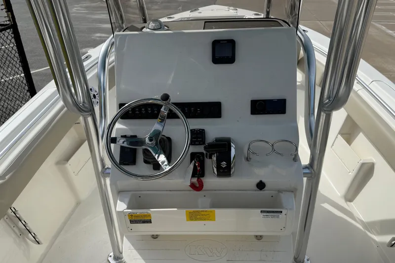 Slide: The Image of Steering console of 2026 Key West 239 FS boat with controls and gauges. - 17