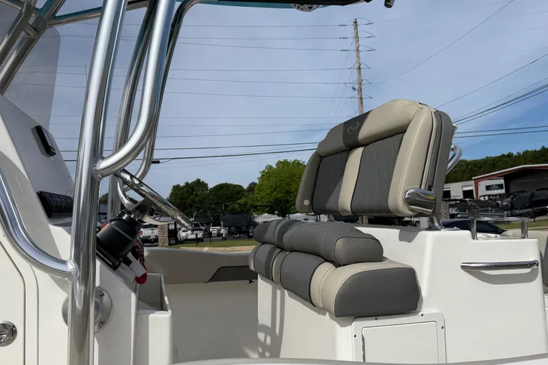 Slide: The Image of 2026 Key West 239 FS boat interior with sleek seating and steering console. - 18