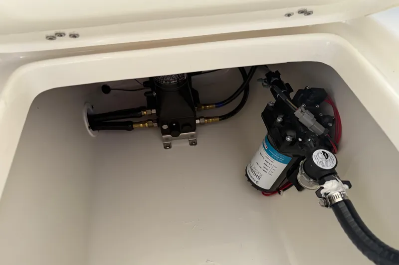 Slide: The Image of Key West 239 FS 2026 boat compartment with pump and wiring components. - 23