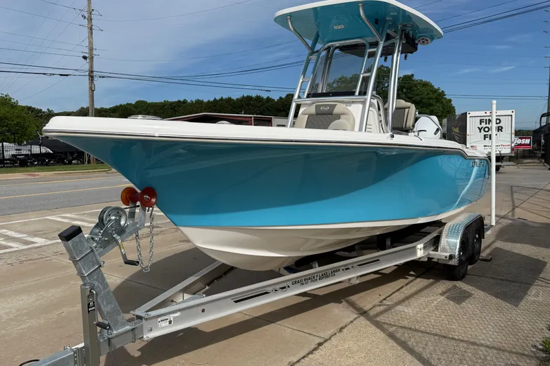 Slide: The Image of 2026 Key West 239 FS boat on trailer, vibrant blue hull, parked outdoors. - 3