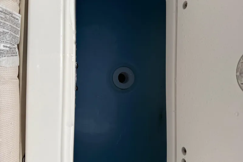 Slide: The Image of 2026 Key West 239 FS boat interior detail with blue compartment and white trim. - 31