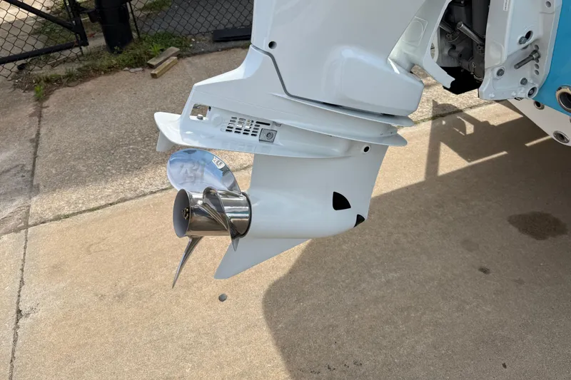 Slide: The Image of Close-up of a 2026 Key West 239 FS boat propeller and motor on concrete surface. - 5