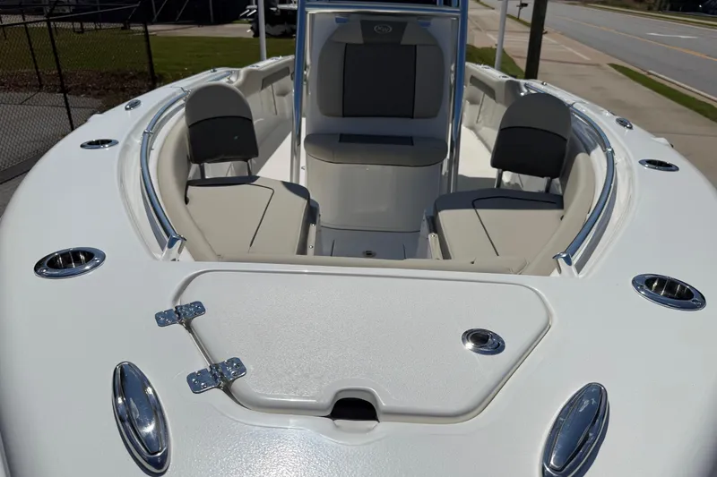 Slide: The Image of 2026 Key West 239 FS boat with spacious seating, parked near a dealership. - 7