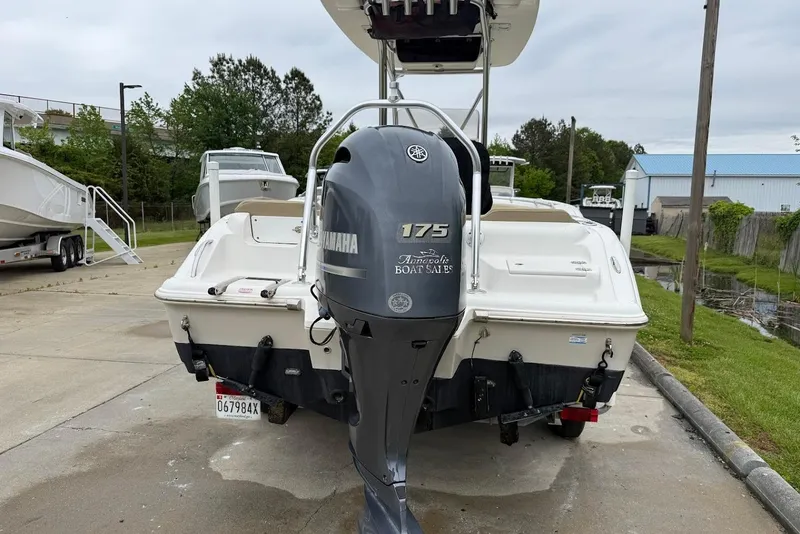 Slide: The Image of 2016 Key West 219 FS boat with Yamaha 175 engine, parked outdoors. - 16