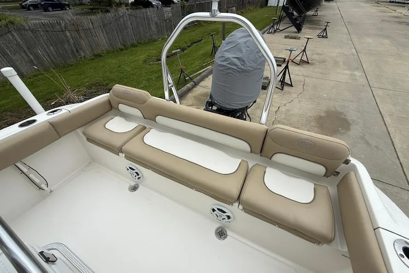 Slide: The Image of 2016 Key West 219 FS boat interior with beige seating and covered engine. - 20