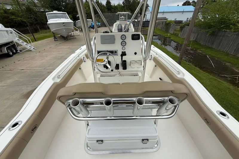 Slide: The Image of 2016 Key West 219 FS boat interior with steering console and rod holders. - 22